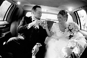 A Bride and Groom enjoy their Wedding Day in the back of a limousine